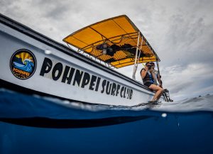 Snorkeler hopping off boat into water from Pohnpei Surf Club boat.