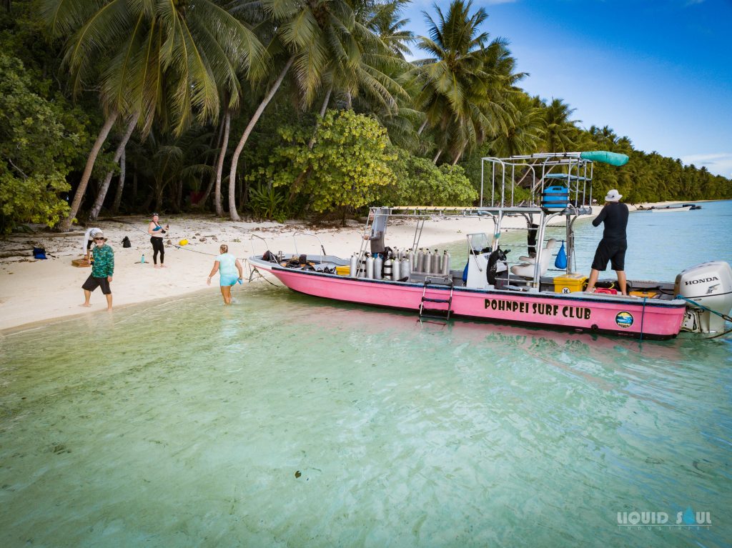 Matnas-851 Pohnpei Surf Club Dive Boat at Ahnd Atoll. Divers relaxing at beach between dives.
